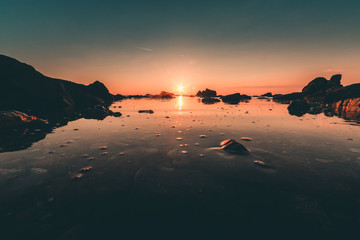 Sunset over a beautiful sea with rocks