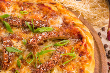 Pizza Suzhuk with the tomato sauce grated by cheese and paprika