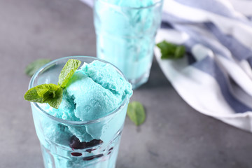 Tasty color ice cream with mint on table