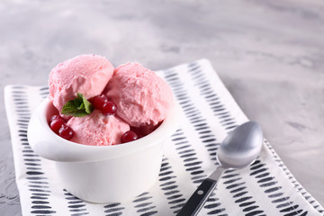 Bowl with tasty ice cream on table