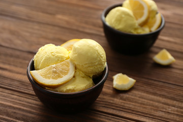 Bowls with tasty color ice cream on wooden table