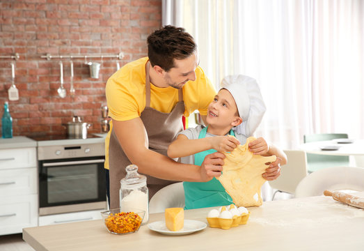 Dad and son cooking at home