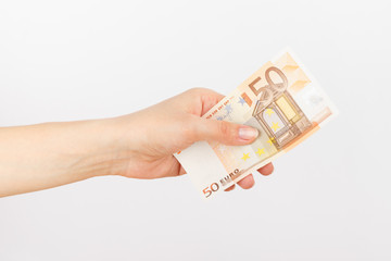 Fifty euro in the woman's hand, light background