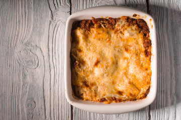 Homemade Meat lasagna on wooden table copy space