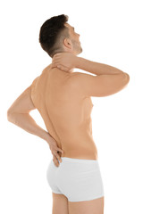 Fototapeta premium Young man suffering from back pain on white background