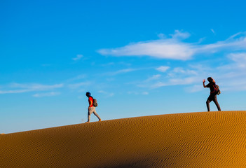 Fototapeta na wymiar two guys in the Sahara desert, Morocco