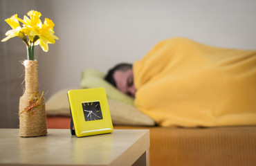 Sleeping man turns off the alarm clock in the morning, wake-up.