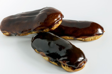 Homemade chocolate eclair on white background