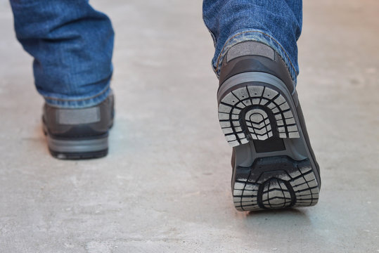 Young Fashion Man's Legs In Jeans And Boots Walking Away, Sole View