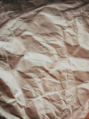 Closeup on crumpled paper textured empty copyspace background