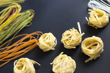 Spaghetti and tagliatelle with ingredients for cooking pasta