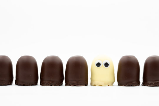 tea cake line - dark and white choco softies with googly eyes on white background