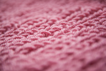 Close up of knitting dirty-pink textured wool background