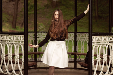 Obraz premium Woman enjoying her time in Europe park with background sunset