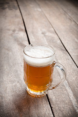glass beer on wood background