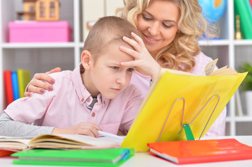 Fototapeta premium Mom and son doing lessons 