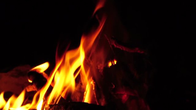 spurts of flame. Campfire in the night. Slow motion

