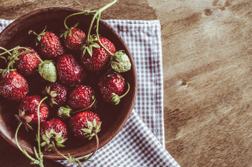 Fresh ripe strawberry on wooden background.