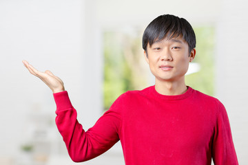 portrait of young asian man pointing