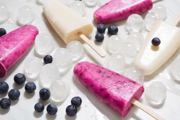 Homemade lolly with yogurt, banana and blueberry