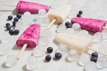 Homemade lolly with yogurt, banana and blueberry