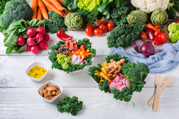 Healthy vegan buddha bowl with kale leaves and raw vegetables