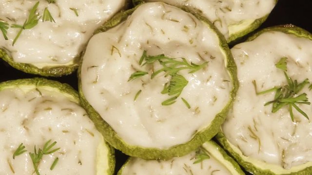 Zucchini snack with with garlic sauce, cooked in the oven. Sauce with garlic, cheese and mayonnaise.