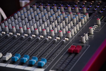 Sound mixer. Professional audio mixing console with lights, buttons, faders and sliders.