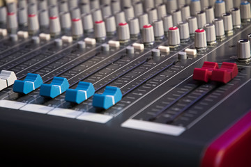 Sound mixer. Professional audio mixing console with lights, buttons, faders and sliders.