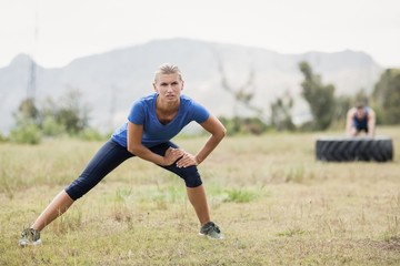 Fit woman exercising in boot camp on a sunny day