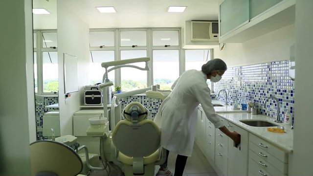 Female dentist at her office working. Young millennial dentist working at her office.
