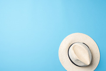 Fototapeta na wymiar Straw hat on blue background
