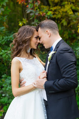 Elegant curly bride and stylish groom