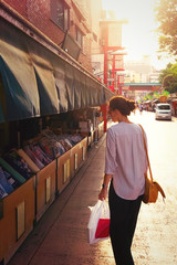 Fototapeta premium Młoda kobieta zakupy tkaniny w Asakusa Tokio o zachodzie słońca