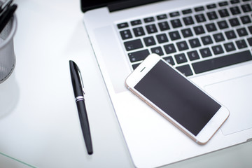 laptop,notebook and phone, smartphone on the table.Office desk table.