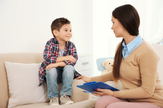 Young child psychologist working with little boy