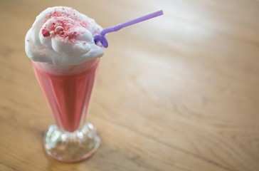 Glass of strawberry shake with cream