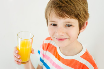 Boy having a glass of refreshing fruit juice