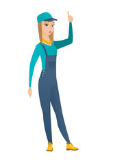 Mechanic with open mouth pointing finger up.