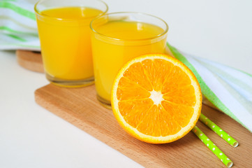 Orange juice in glass with mint, fresh fruits on white background