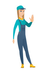 Caucasian mechanic showing stop hand gesture.
