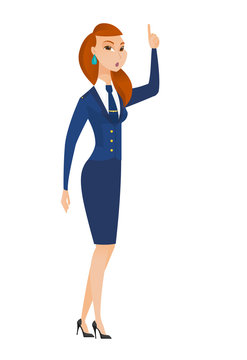 Stewardess with open mouth pointing finger up.