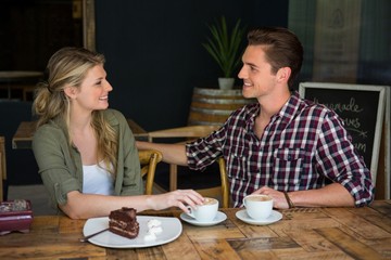 Loving couple talking at table in coffee shop