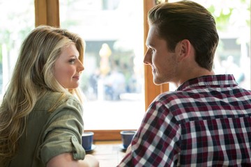 Loving couple looking at each other in coffee house