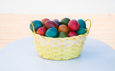 Fototapeta na wymiar Basket of natural Easter Eggs dyed in various colours - Eastern European Traditional style