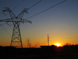 Fototapeta na wymiar View of sunset looking through powerlines