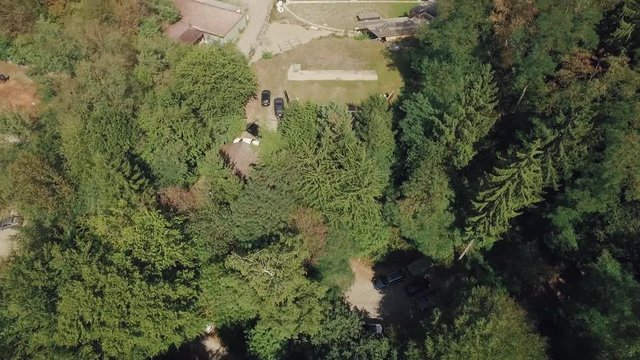 Drone flight over wood and gun shooting range at lonely stone pit
