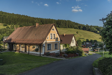 Fototapeta na wymiar Sunny summer day in Krkonose mountains with countryside house