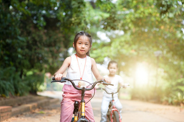 Naklejka na ściany i meble Children riding bikes outdoor.