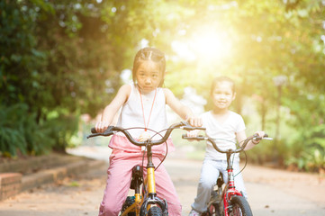 Fototapeta na wymiar Children riding bikes outdoor.